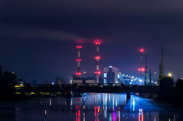 GENERATING STATION - Chimneys and power station buildings at night
