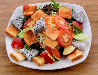 vegetable salad in white plate  on wooden background