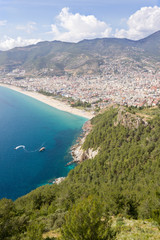 View of the beach from the mountain, around the forest, in the sea ships