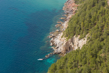 View from above on a boat in a beautiful bay with clear water near the rocks