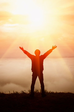 Man raised his arms on the hill