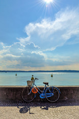 Fototapeta premium italian bike on wall in sunny day in small town italy on lake garda