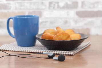 Chinese fried Dough bun with cup of coffee and headphone