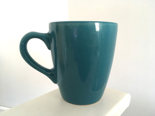 Blue Mug Against Pale Grey Background