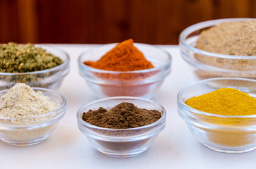 Different kind of colorful spices powder in glass bowls. Food and cuisine additives.