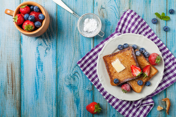 Fototapeta na wymiar Traditional, delicious, sweet French toast with fruit and butter.