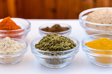 Different kind of colorful spices powder in glass bowls. Food and cuisine additives.