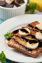 Traditional, delicious, sweet French toast with fruit and butter.