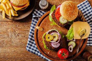 Homemade, beef hamburger with cheese and vegetables.