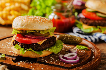 Homemade, beef hamburger with cheese and vegetables.