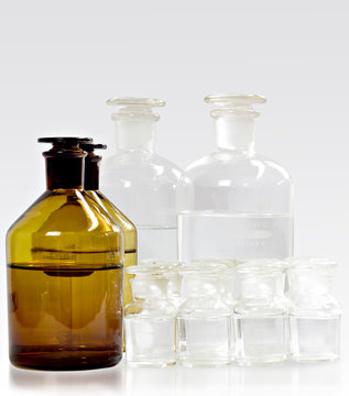Glass bottles clear and amber for pharmacy bottles or science laboratory on white background.