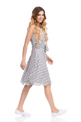 Walking Woman In White Summer Dress And Sneakers