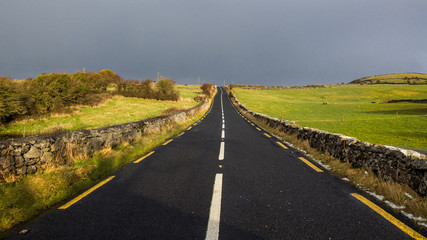 Road rural through Ireland with a gloomy sky
