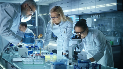 Team of Medical Research Scientists Work on a New Generation Disease Cure. They use Microscope,...