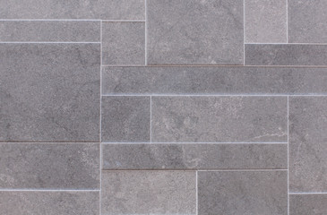 Ladrillos grises y asimétricos. La fotografía busca la textura del ladrillo.