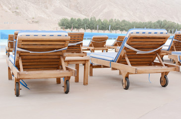Swimming pool and deck chairs at the resort. United Arab Emirates