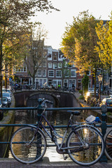 Fototapeta na wymiar Bicycles and boats at streets of Amsterdam in autumn