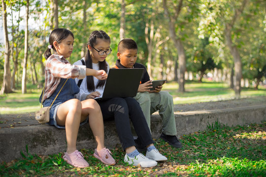 young students in garden learning and working together