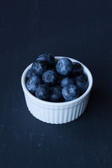 blueberry in a bowl on a black background