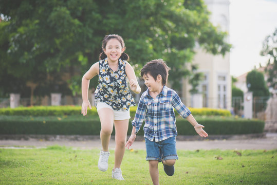 Cute Asian children runing together