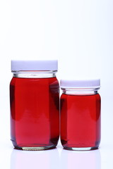 Red Liquid in Glass Bottle white cap