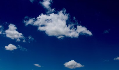 The white clouds in the blue sky.