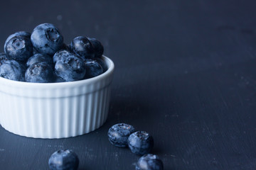 blueberry in a bowl on a black background