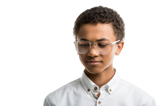 Portrait Of African American Teenager In Eyeglasses And White Shirt Looking Away Isolated On White