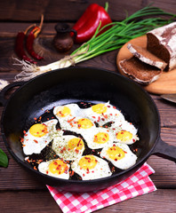 Fried eggs in a black cast-iron frying pan
