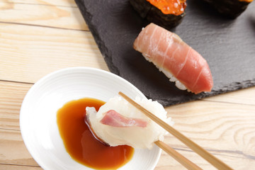 Sea bream sushi dipping in soy sauce - 166980744