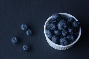 blueberry in a bowl on a black background