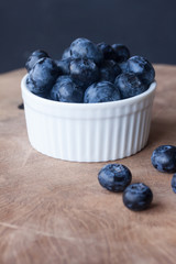 Blueberry in a bowl on a wood background