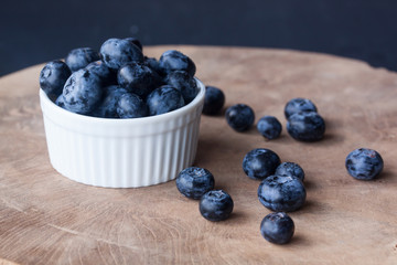 Blueberry in a bowl on a wood background