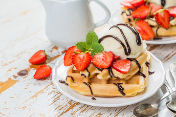 Waffles with strawberry, ice cream and chocolate