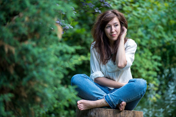 young girl is sitting with crossed legs