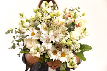 Big floral bouquet in woman's hands