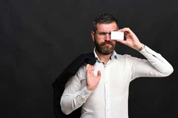 Businessman with grumpy face and glasses on black texture background