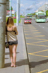 Young girl, student waiting for public transport
