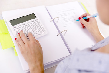 Female accountant or banker making calculations. Savings, finances and economy concept