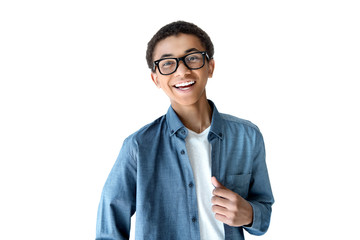 portrait of cheerful african american teenage boy in eyeglasses looking at camera isolated on white