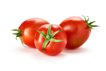 Three fresh ripe red tomatoes isolated on a white background