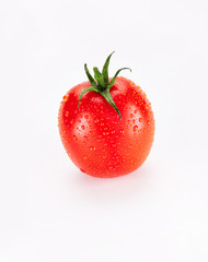 A washed bright red ripe chilled plum tomato isolated on a white background