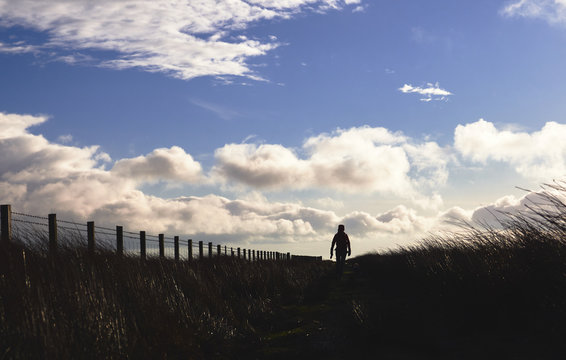 A hiker exploring the English Countryside, Muggleswick Common near Edmundbyers, England UK.