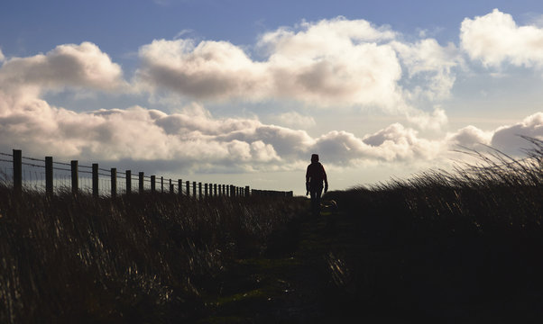 A hiker exploring the English Countryside, Muggleswick Common near Edmundbyers, England UK.