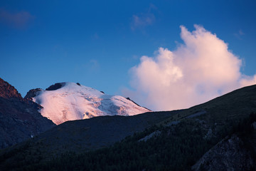 Mountain peak with glacier at sunset