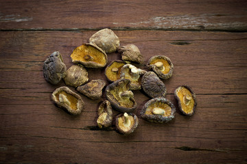 Dried Mushrooms on wooden background.