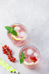 Red currant infused water on stone background. Top view, space for text.