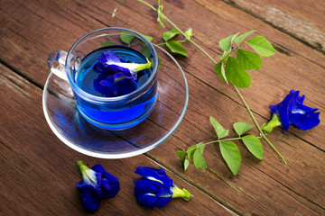 Butterfly pea in cup  on wood background