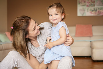 Mother with her  daughter at home.