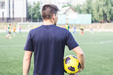 man holding a soccer ball on the field